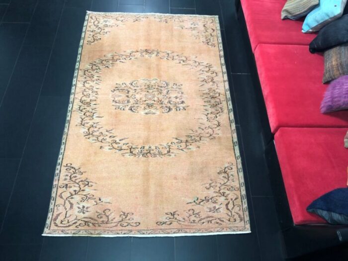 orange faded oushak rug 1